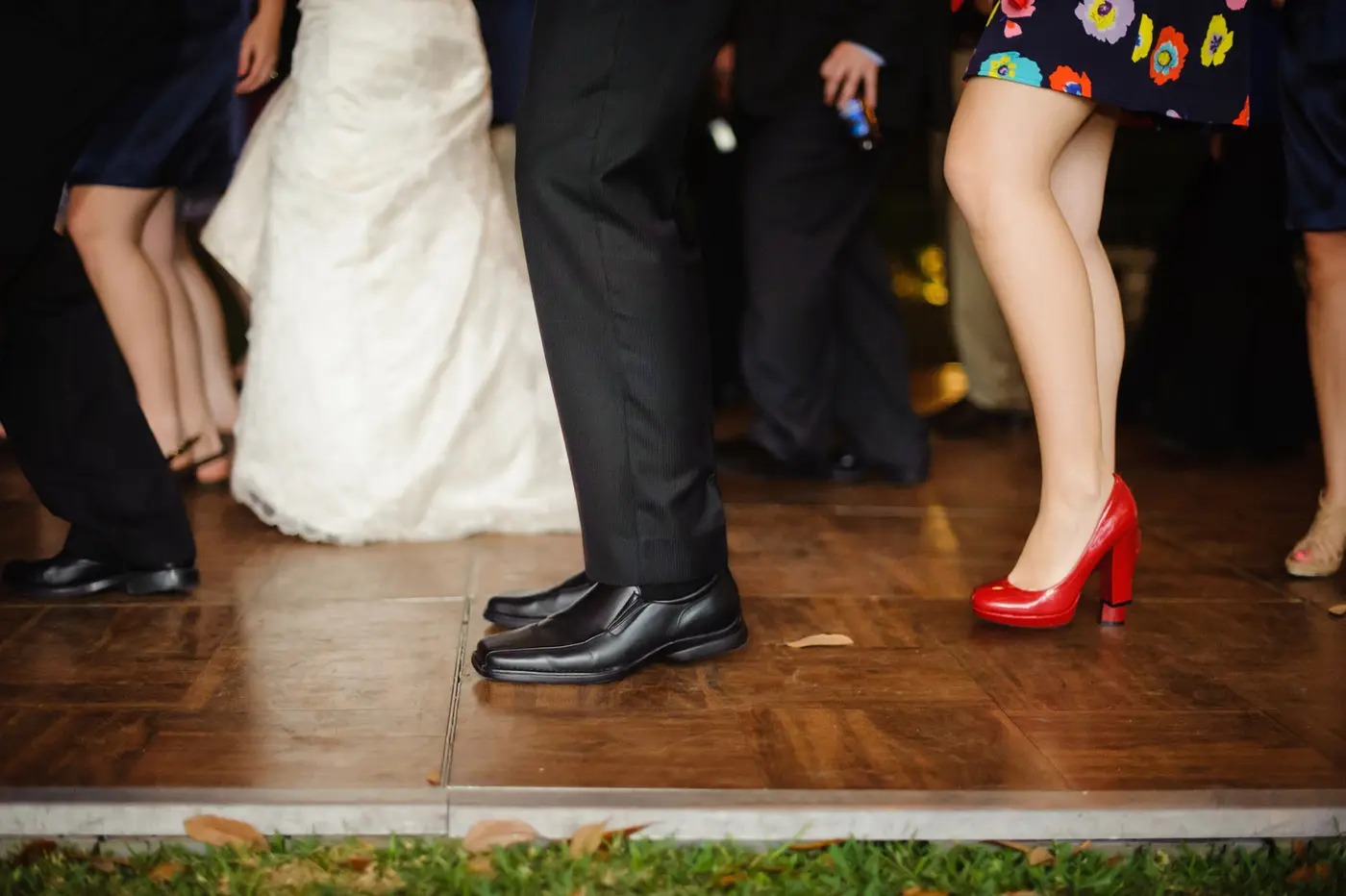 Legs down image of people dancing at wedding reception.